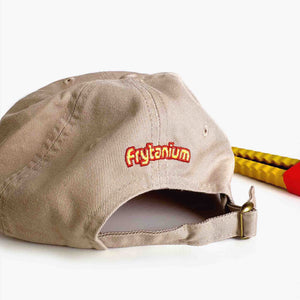 A beige baseball hat with Frytanium embroidered on the back. 